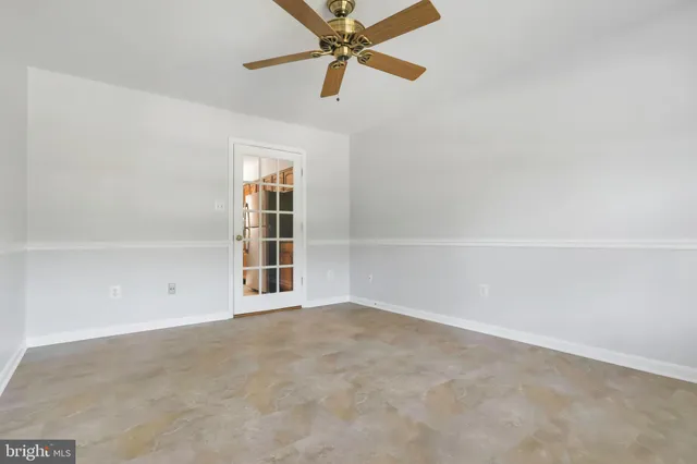 an empty room with closet and windows