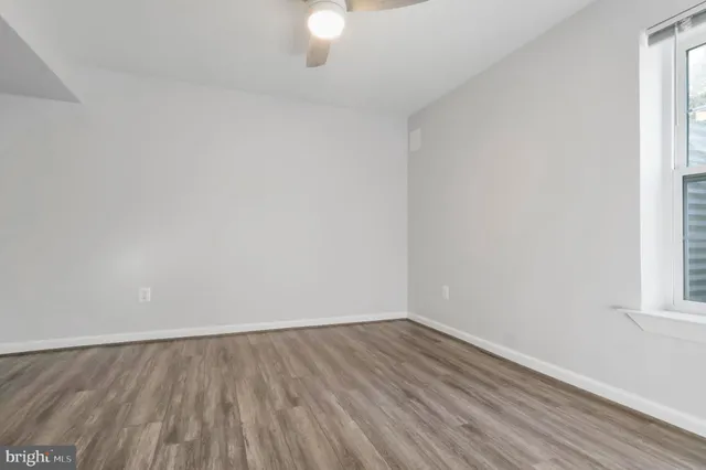 a bathroom with a granite countertop toilet sink and mirror