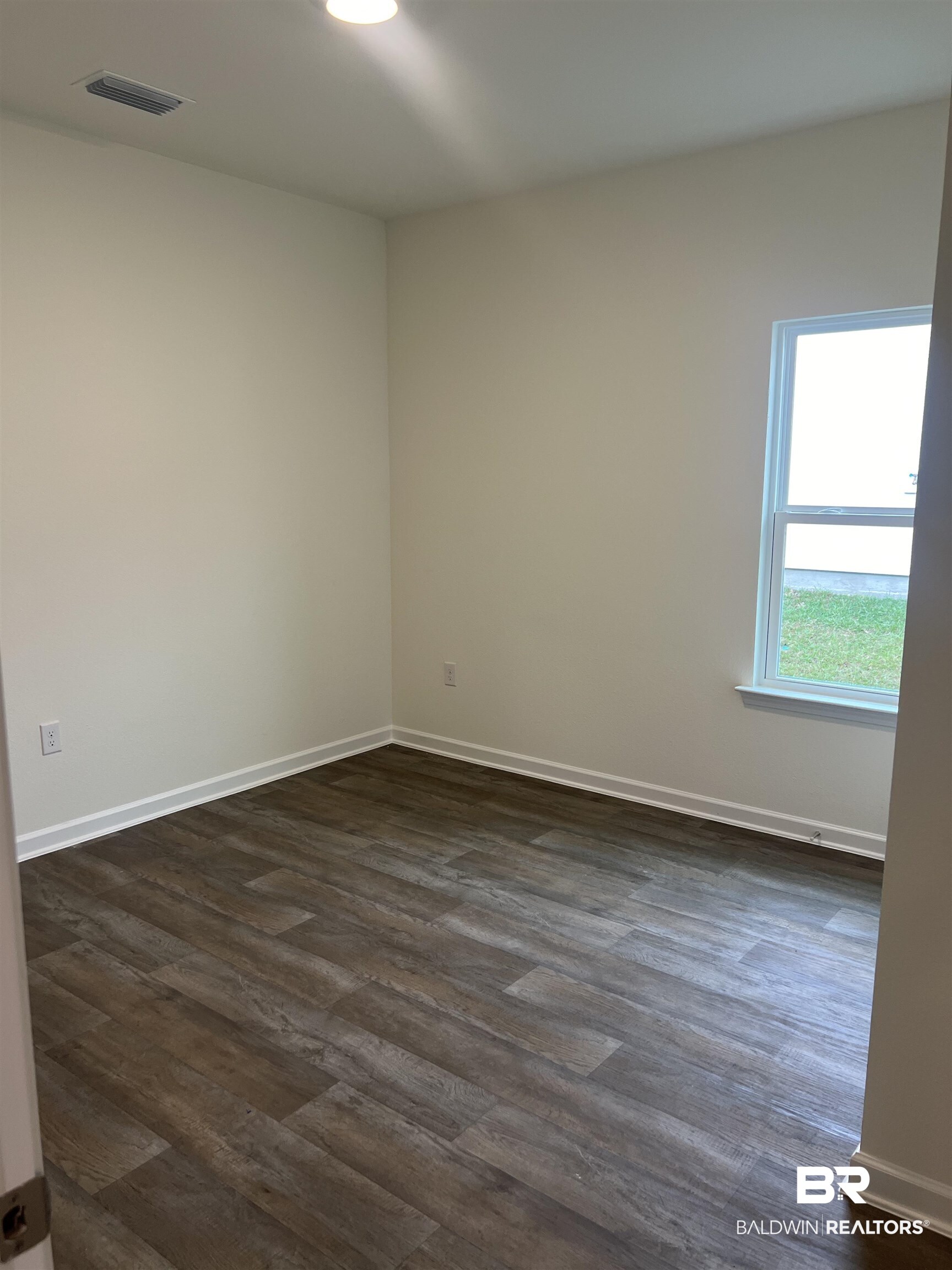12829 Patriot Way Daphne, AL 36527 - Photo 7 of 38 Empty room with dark wood-type flooring