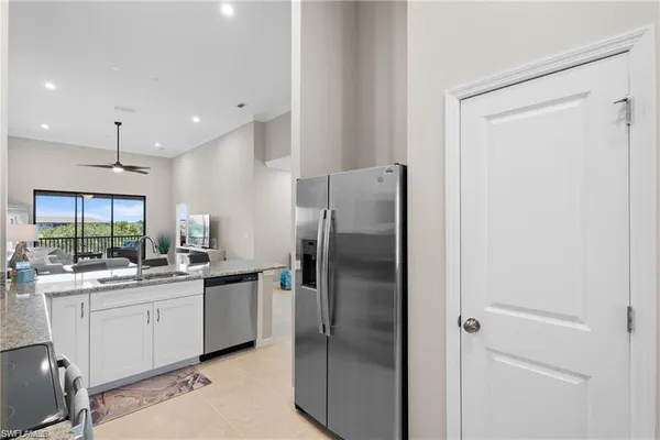 a kitchen with a sink stainless steel appliances and cabinets
