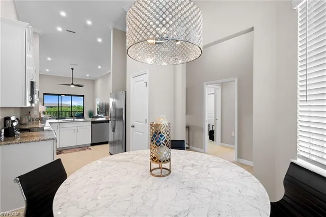a kitchen with stainless steel appliances wooden floor dining table and chairs