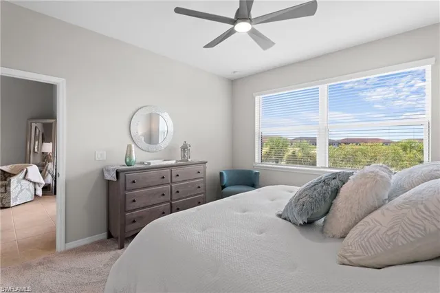 a bedroom with a bed and a mirror on the dresser