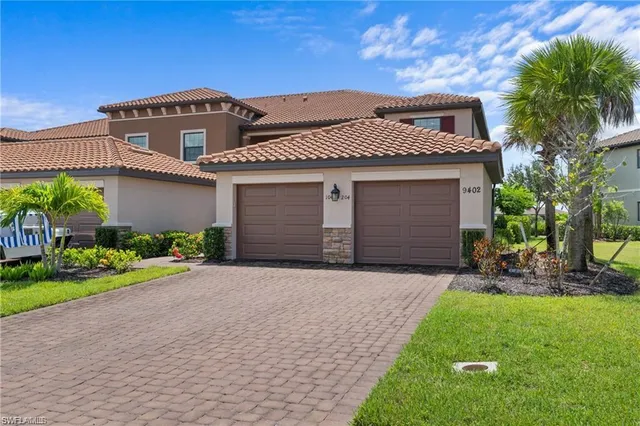 a front view of a house with a garden and yard