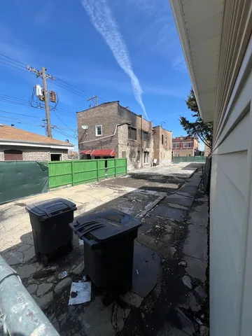a view of yard from deck with patio