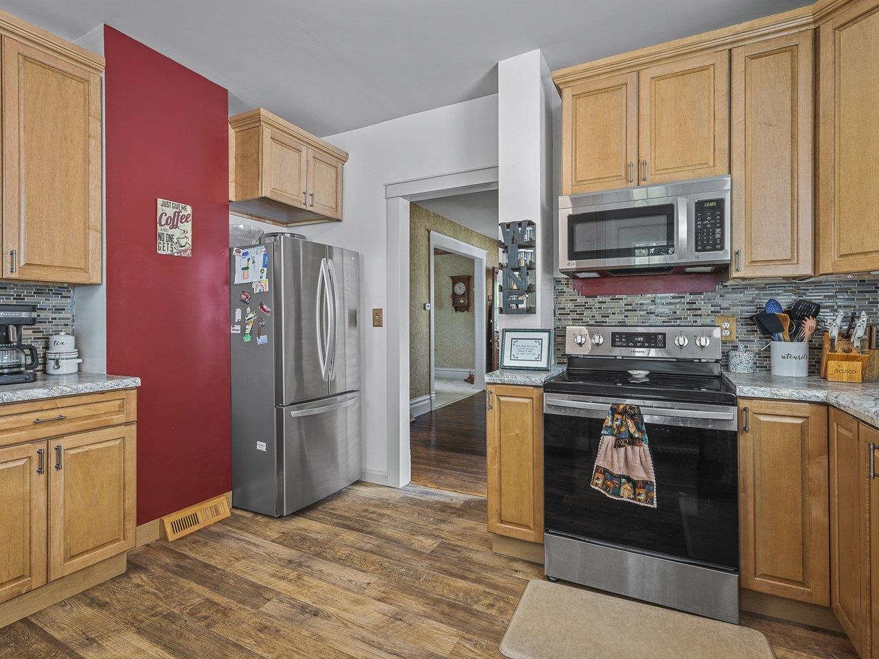 250 Edward Street Sycamore, IL 60178 - Photo 14 of 31 a kitchen with stainless steel appliances granite countertop a stove a refrigerator and a sink