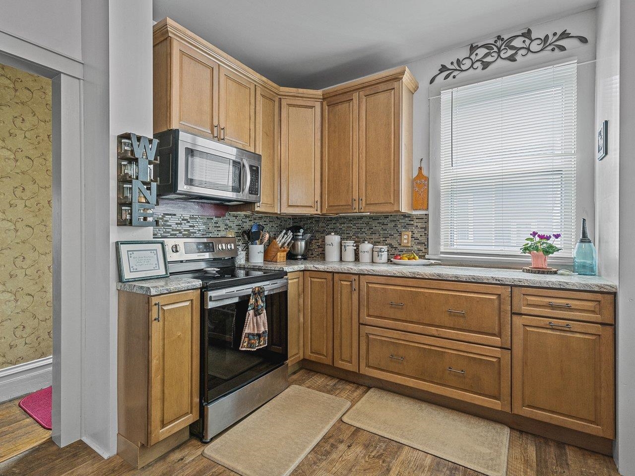 250 Edward Street Sycamore, IL 60178 - Photo 15 of 31 a kitchen with granite countertop cabinets stainless steel appliances and a sink