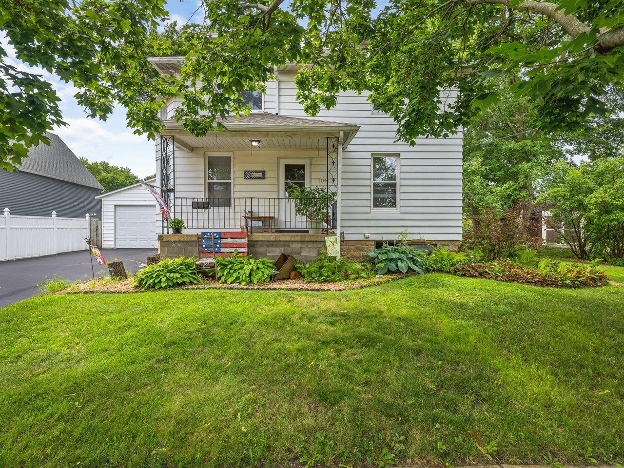 250 Edward Street Sycamore, IL 60178 - Photo 3 of 31 a front view of a house with a yard and trees