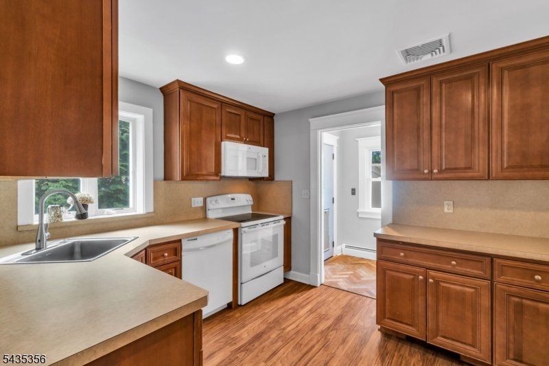 105 Somerville Road Bedminster, NJ 07921 - Photo 10 of 36 a kitchen with a sink cabinets stainless steel appliances and a window