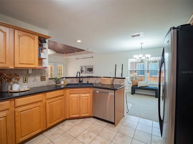a kitchen with stainless steel appliances granite countertop a sink and cabinets