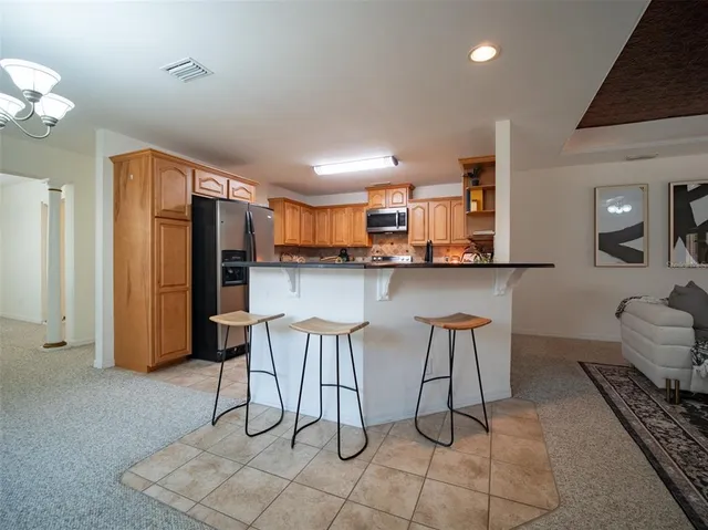 a kitchen with stainless steel appliances kitchen island granite countertop a sink and cabinets
