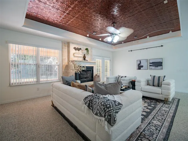 a living room with furniture a large window and a fireplace