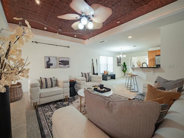 a living room with furniture and a chandelier