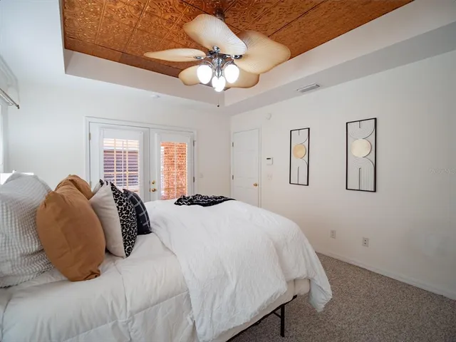 a bedroom with a bed and a chandelier