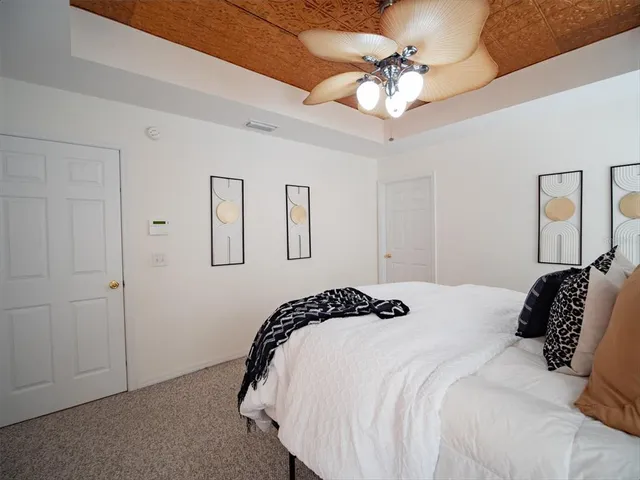 a bedroom with a bed and a chandelier