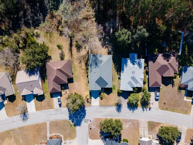 an aerial view of multiple houses with yard