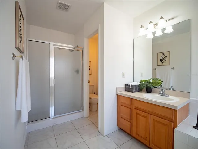 a bathroom with a shower and a glass door