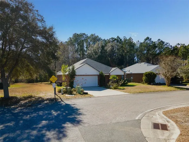 a view of a house with backyard and sitting area