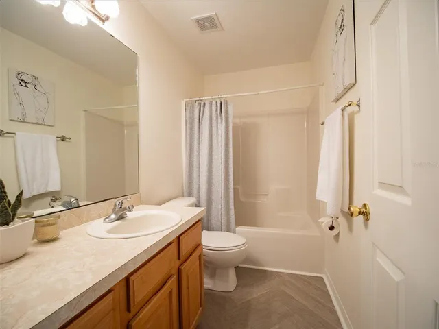 a bathroom with a sink vanity and a mirror