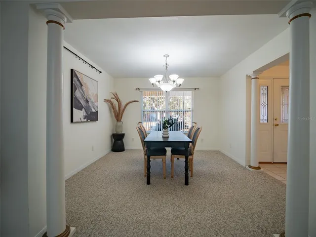 a dining room with furniture and chandelier