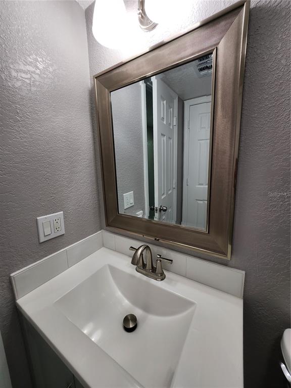 5541 Bay Boulevard, Unit 403 Port Richey, FL 34668 - Photo 15 of 24 a bathroom with a sink and a mirror