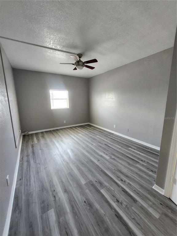 5541 Bay Boulevard, Unit 403 Port Richey, FL 34668 - Photo 16 of 24 wooden floor in an empty room