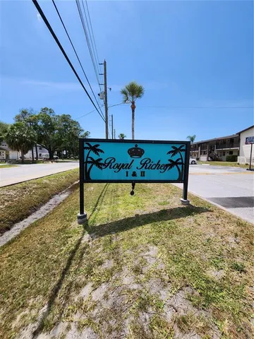 a living room with couches a computer on the desk and chair