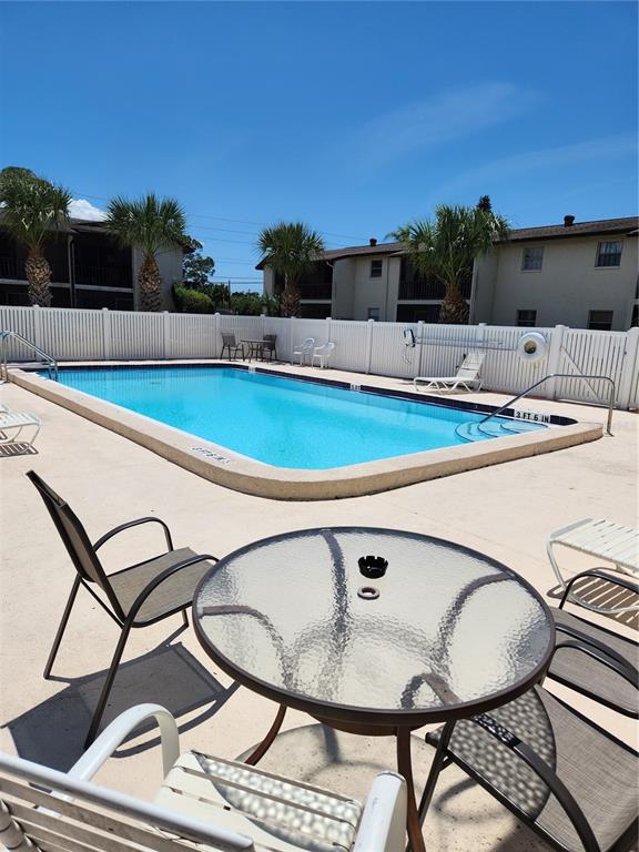 5541 Bay Boulevard, Unit 403 Port Richey, FL 34668 - Photo 22 of 24 a view of a chairs and table in the terrace