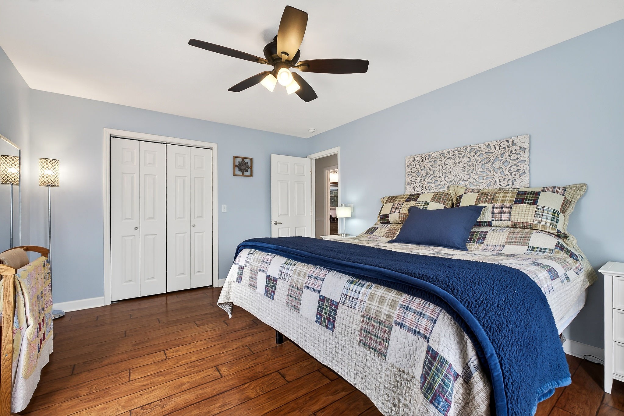 1445 Tom Grissom Road Morrison, TN 37357 - Photo 15 of 42 a bed sitting in a bedroom next to a window and a chandelier