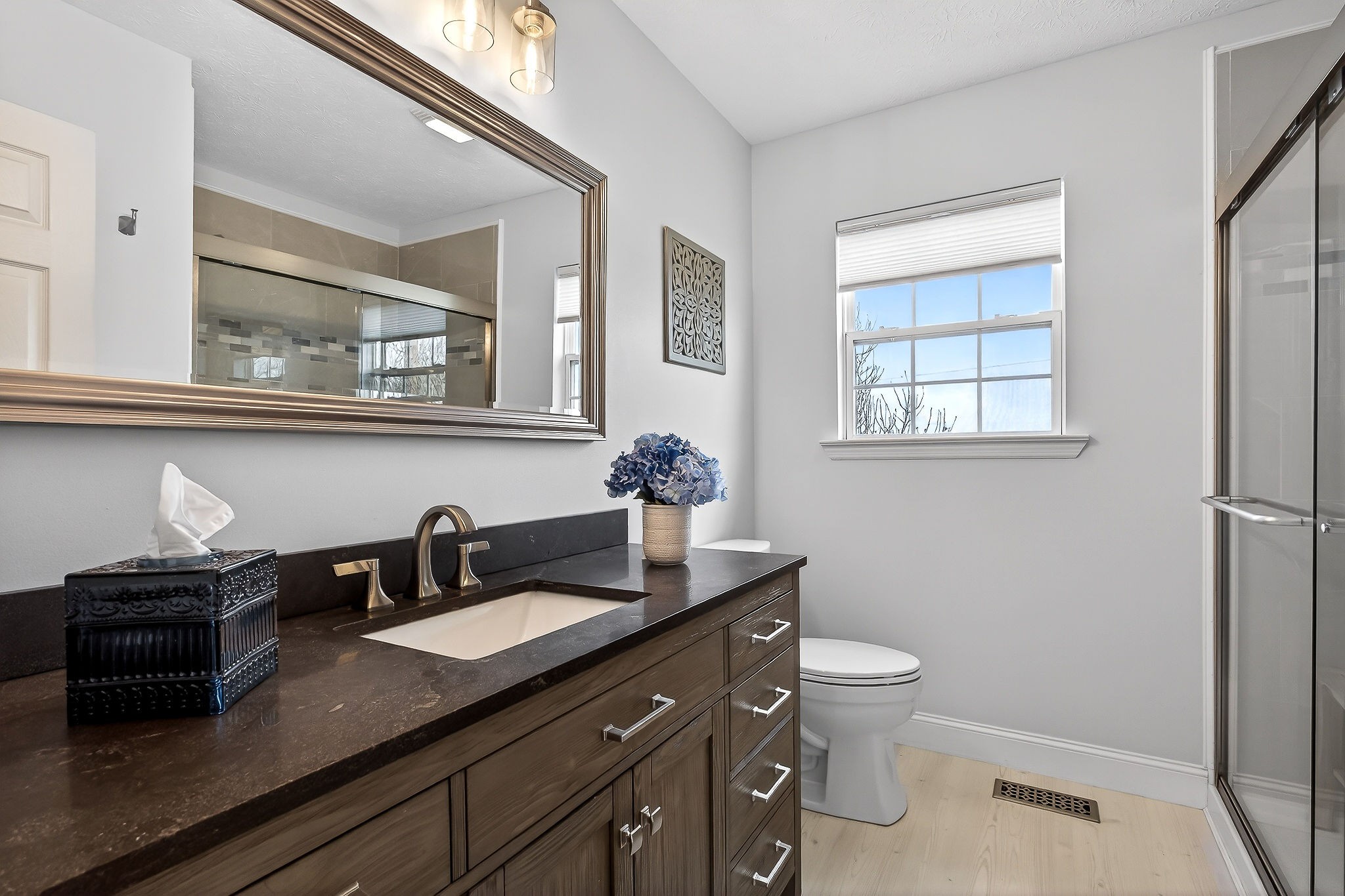 1445 Tom Grissom Road Morrison, TN 37357 - Photo 17 of 42 a bathroom with a granite countertop sink a toilet and a mirror