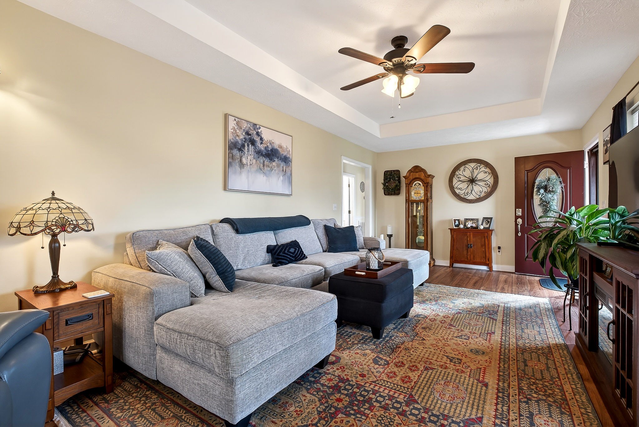 1445 Tom Grissom Road Morrison, TN 37357 - Photo 2 of 42 a living room with furniture a clock on wall and a chandelier