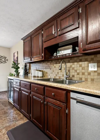 a kitchen with stainless steel appliances granite countertop a stove a refrigerator and a sink