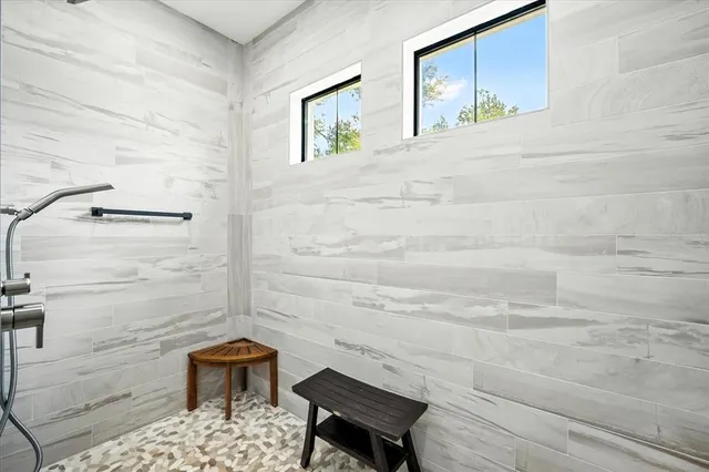 a kitchen with stainless steel appliances a dining table chairs and window