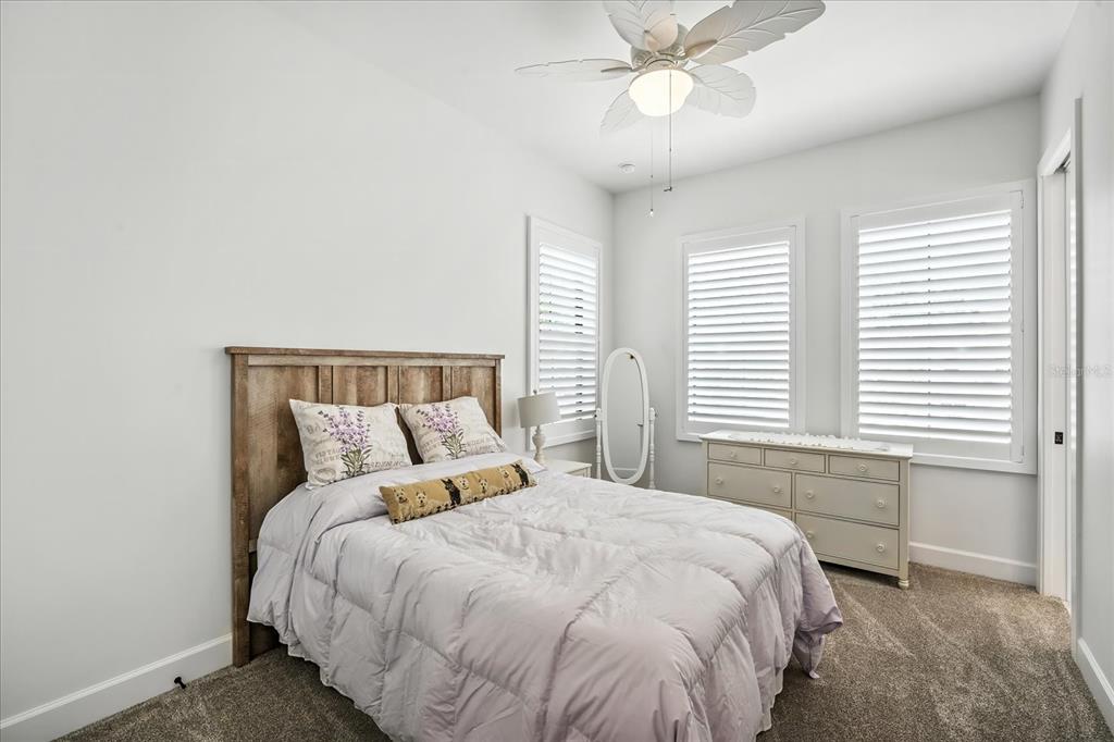 8317 Alafia Pointe Drive Riverview, FL 33578 - Photo 30 of 47 a bedroom with a large bed and a large window