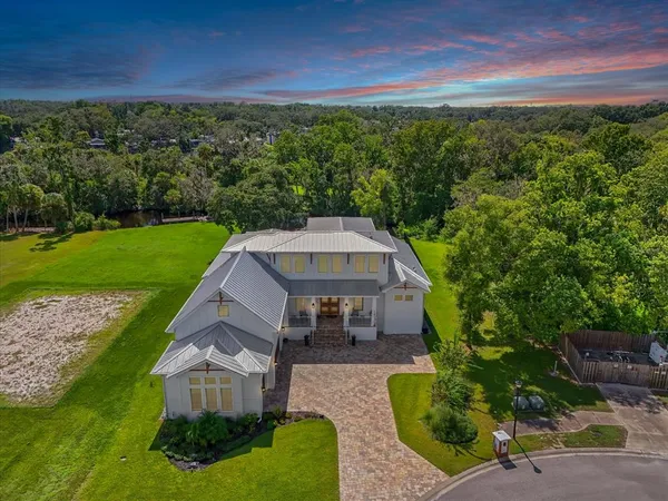 an aerial view of a house with a yard