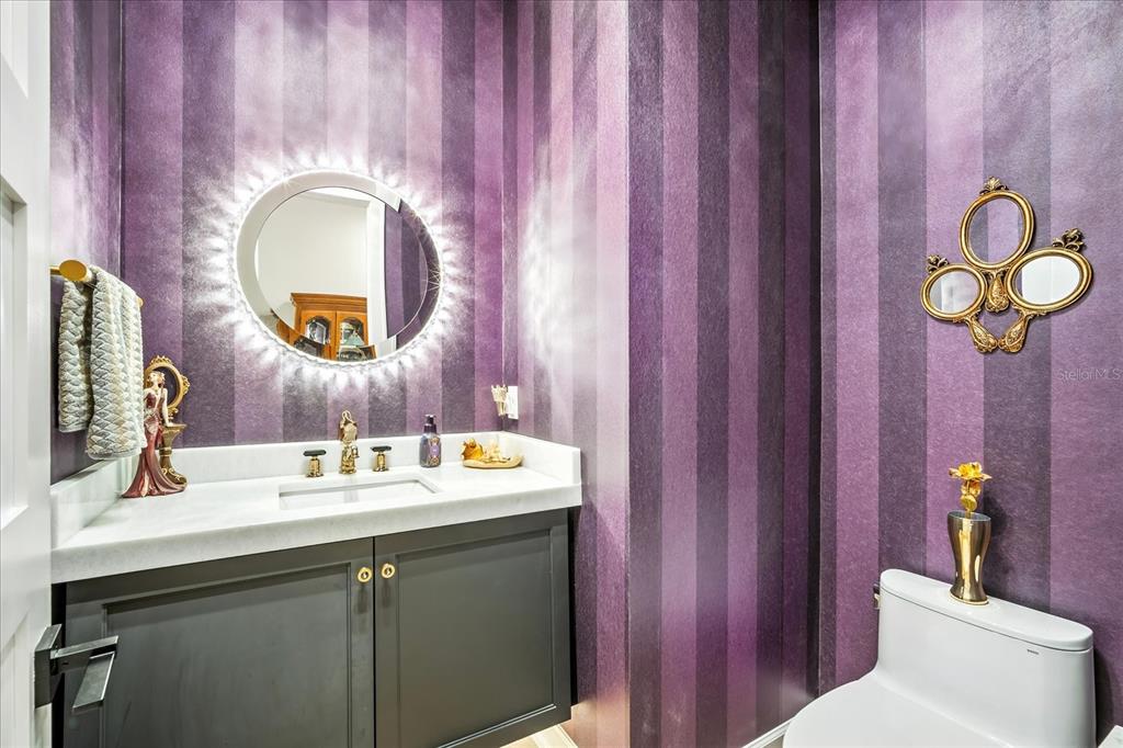 8317 Alafia Pointe Drive Riverview, FL 33578 - Photo 34 of 47 a bathroom with a granite countertop toilet a sink and mirror