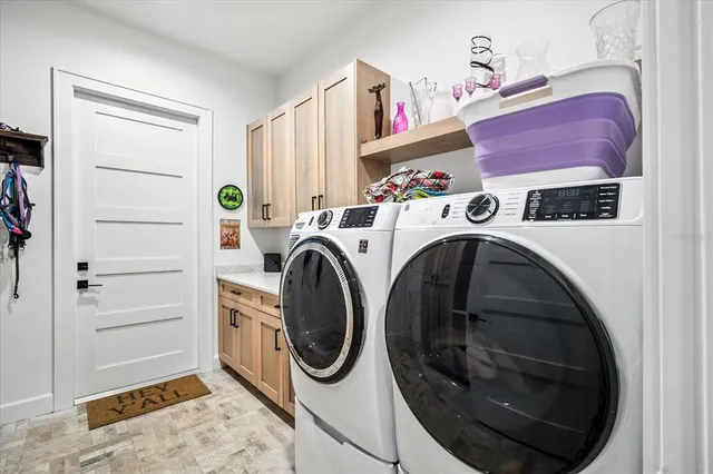 a view of a kitchen with washer and dryer