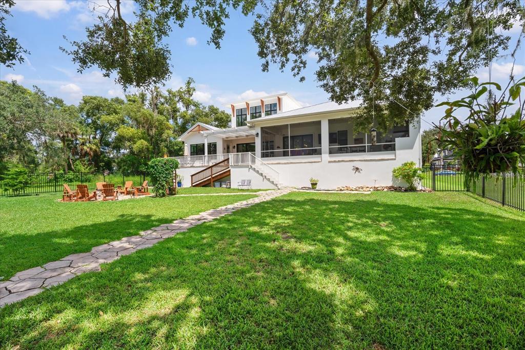 8317 Alafia Pointe Drive Riverview, FL 33578 - Photo 42 of 47 a view of a house with a big yard and potted plants and large trees