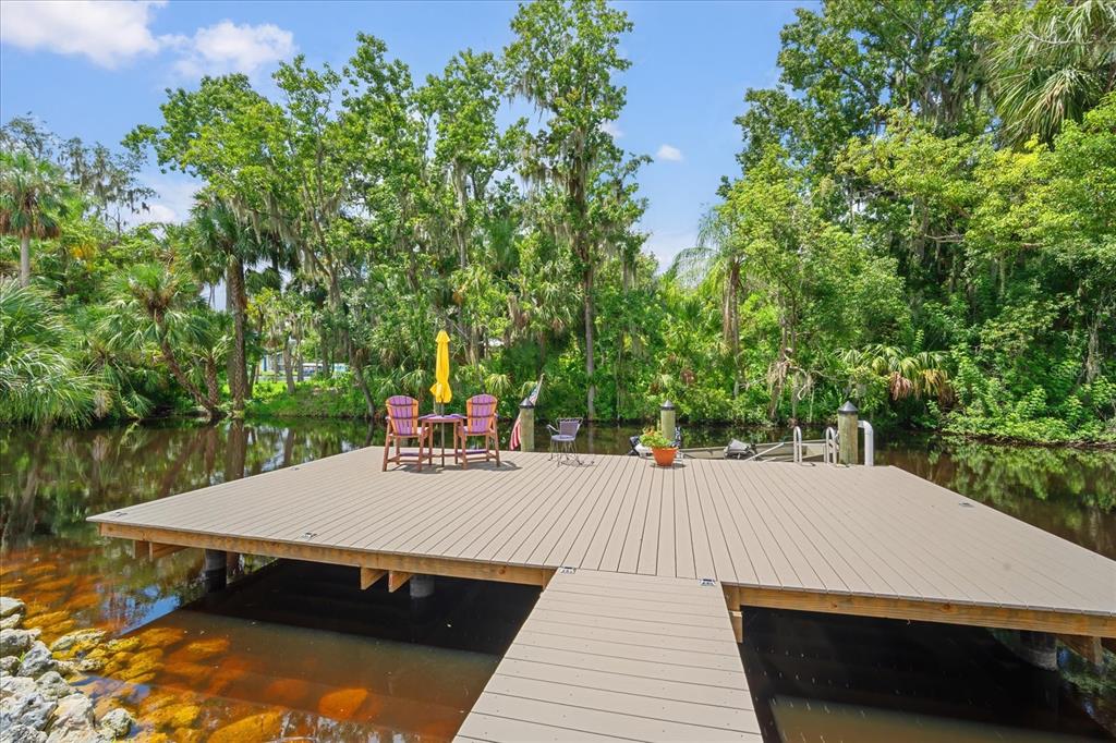 8317 Alafia Pointe Drive Riverview, FL 33578 - Photo 43 of 47 a view of a patio with table and chairs with wooden floor and fence
