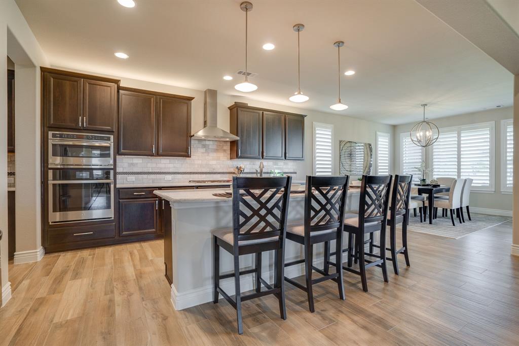 a large kitchen with a table and chairs