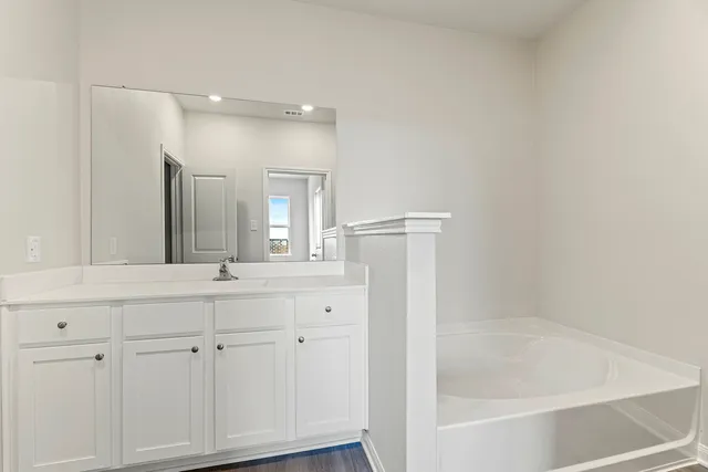 a bathroom with a bathtub and a sink