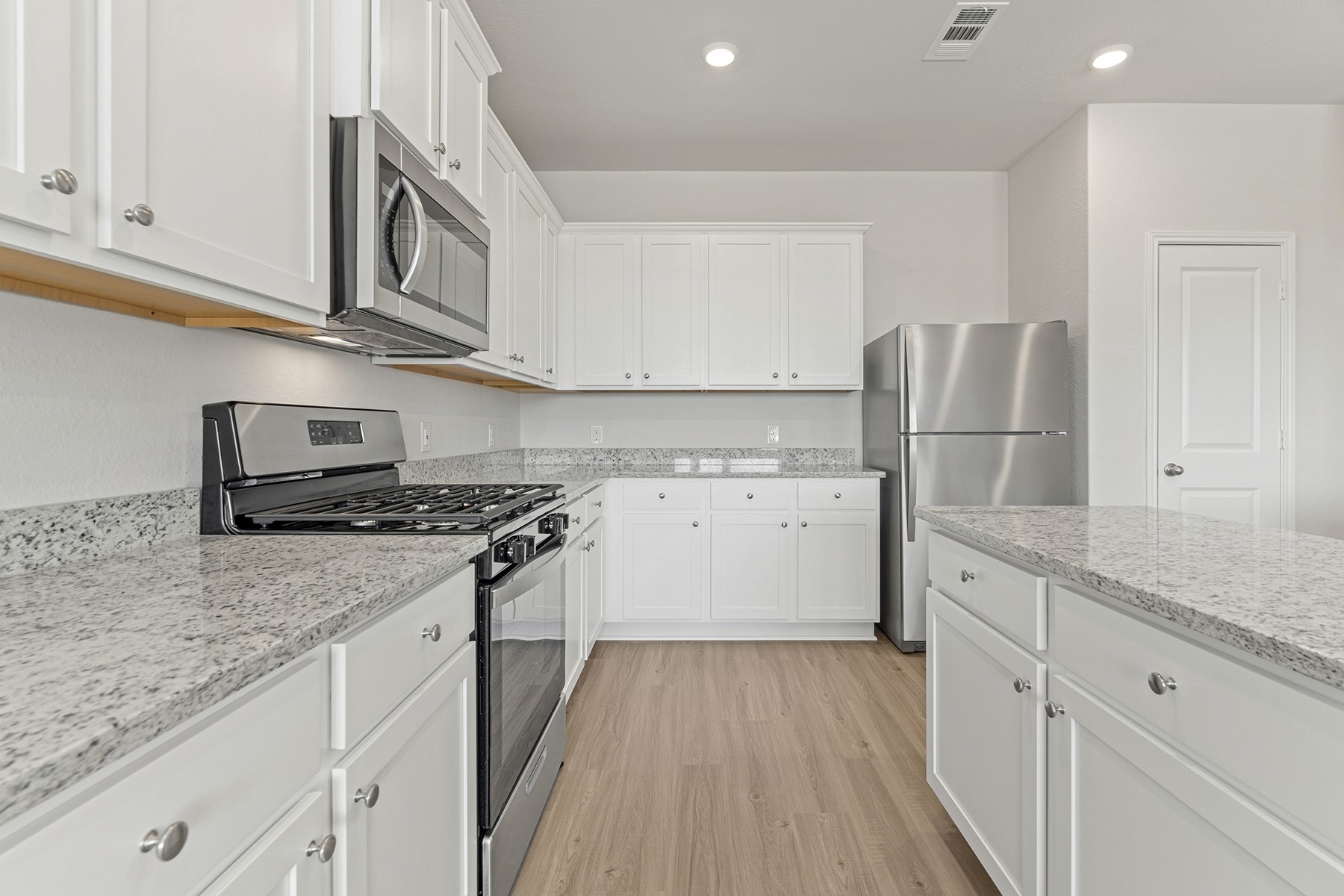 1131 Campside Drive Beasley, TX 77417 - Photo 7 of 15 a kitchen with granite countertop a sink stove and refrigerator