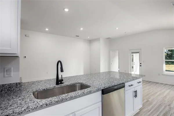a kitchen with a sink and a refrigerator