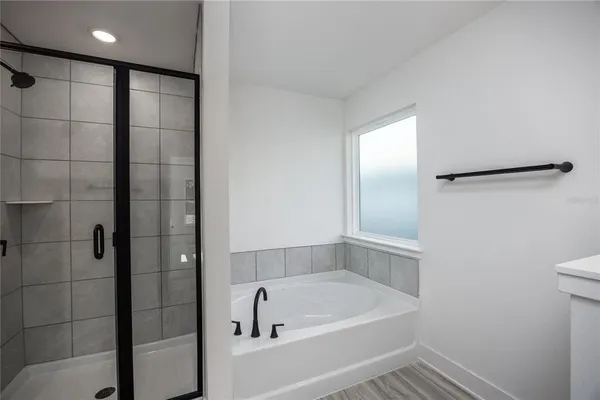 a bathroom with a tub and shower