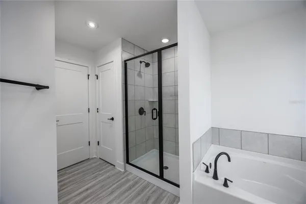 a bathroom with a bathtub and a shower