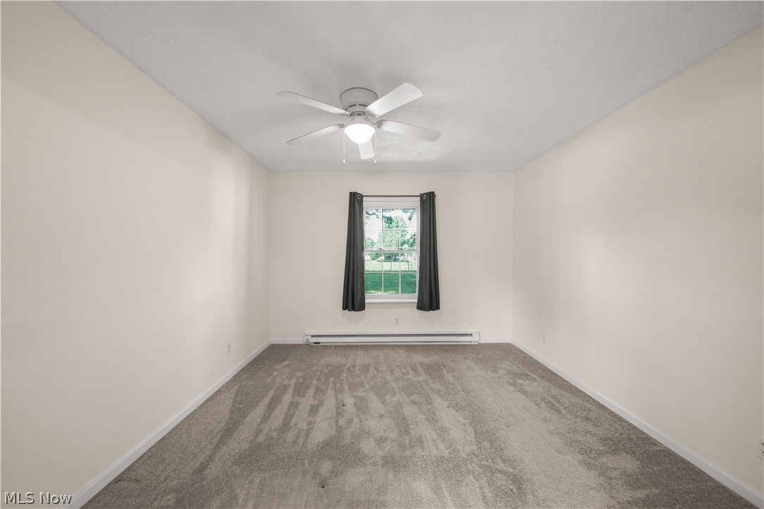 3796 North Santom Road Stow, OH 44224 - Photo 18 of 30 Neutral-toned walls and grey carpeting define this room, featuring a white ceiling fan with integrated lighting