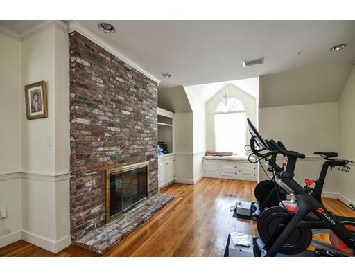 73 Pheasant Landing Road Needham, MA 02492 - Photo 16 of 23 a living room with a wooden floor and a fireplace