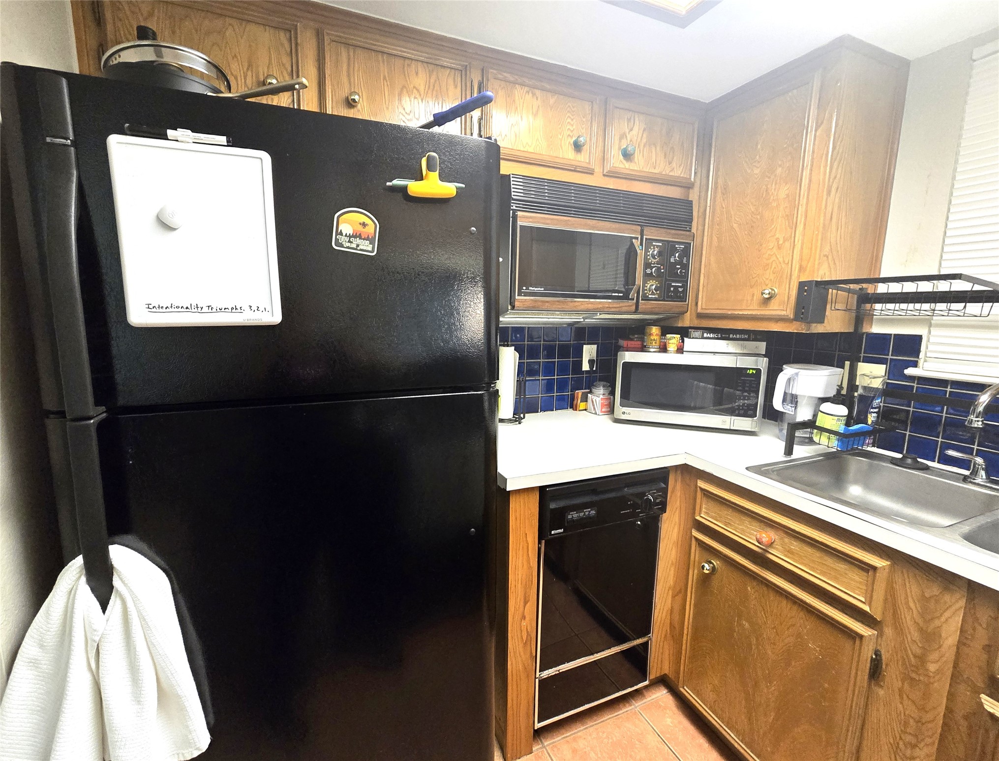 706 West 22nd Street, Unit 307 Austin, TX 78705 - Photo 11 of 20 a kitchen with stainless steel appliances granite countertop a refrigerator a sink a stove and island