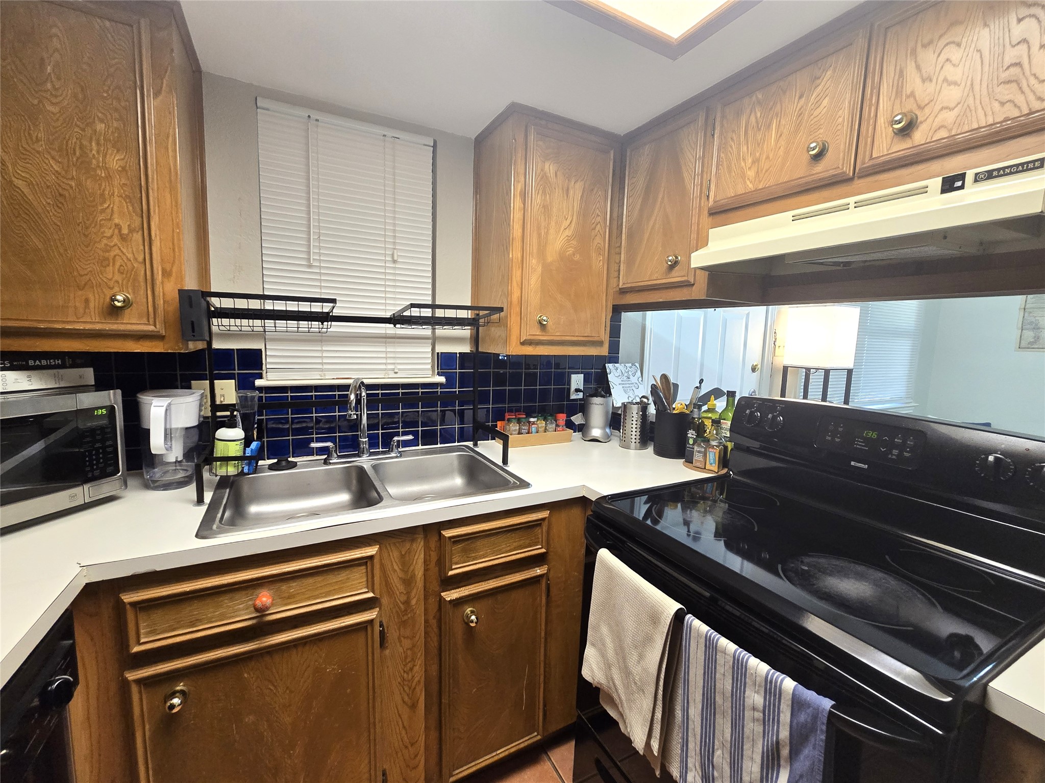 706 West 22nd Street, Unit 307 Austin, TX 78705 - Photo 12 of 20 a kitchen with a sink stove and cabinets