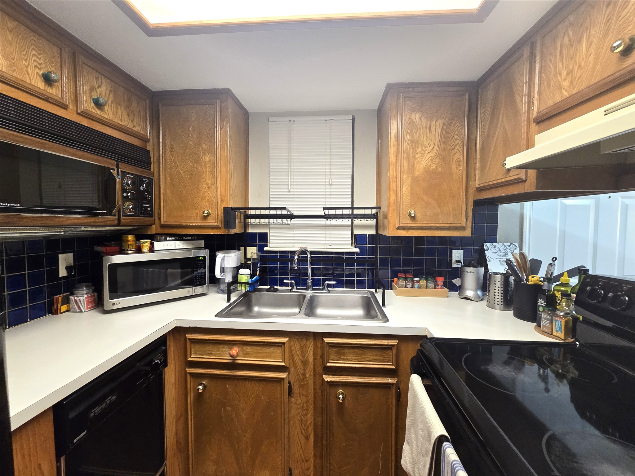 706 West 22nd Street, Unit 307 Austin, TX 78705 - Photo 13 of 20 a kitchen with stainless steel appliances a sink a stove a microwave a sink a refrigerator and cabinets