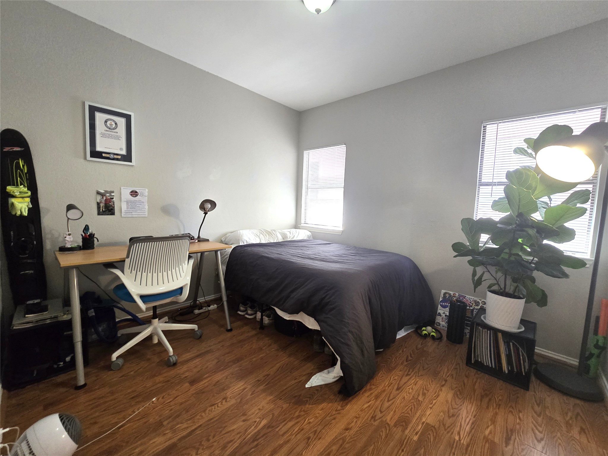 706 West 22nd Street, Unit 307 Austin, TX 78705 - Photo 4 of 20 a bedroom with a bed chairs and a potted plant